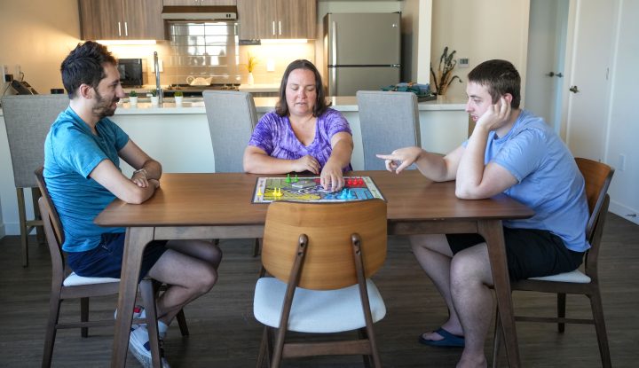 Young adults with autism navigating a game in supportive housing.